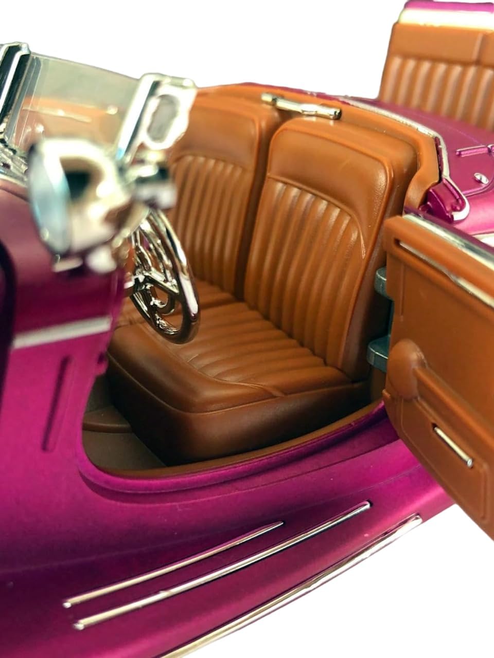 Close-up of a toy car with brown interior and pink exterior